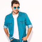 Portrait of handsome smiling stylish hipster lumbersexual businessman model wearing jeans clothes and sunglasses. Fashion man isolated on white